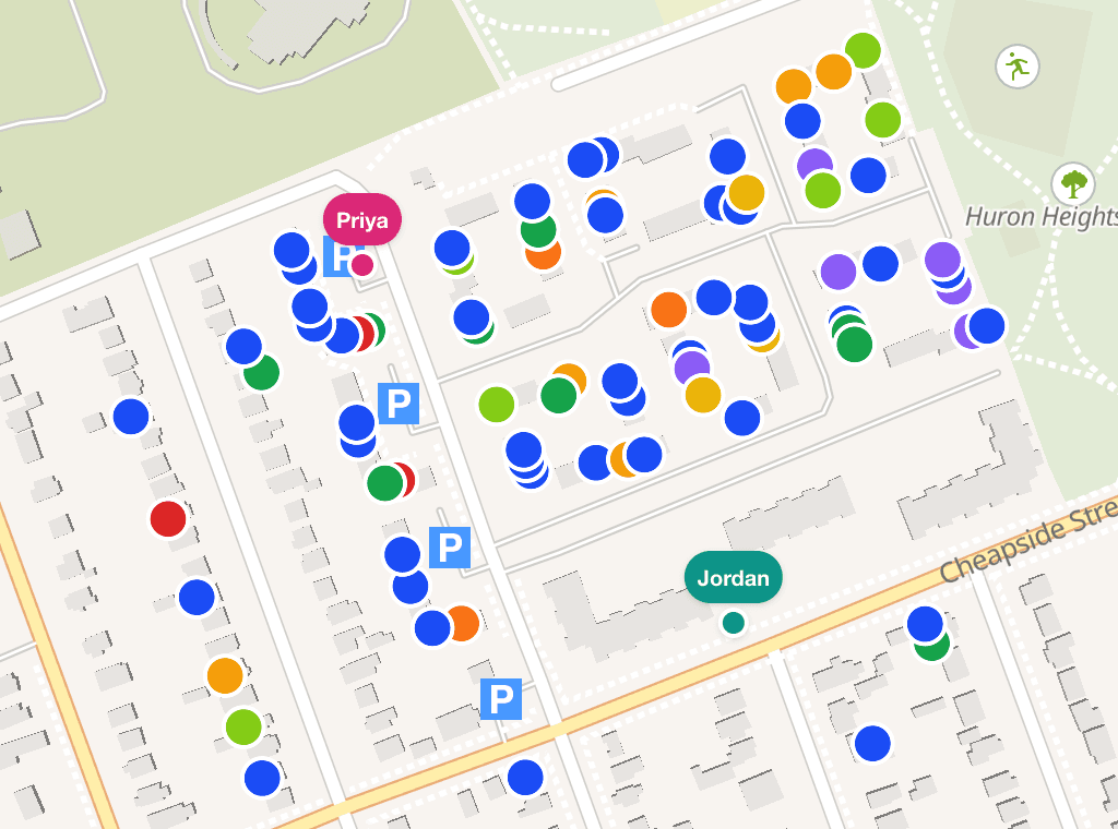 The DoorLine live canvassing map: colored pins on real houses plus teammates' GPS positions